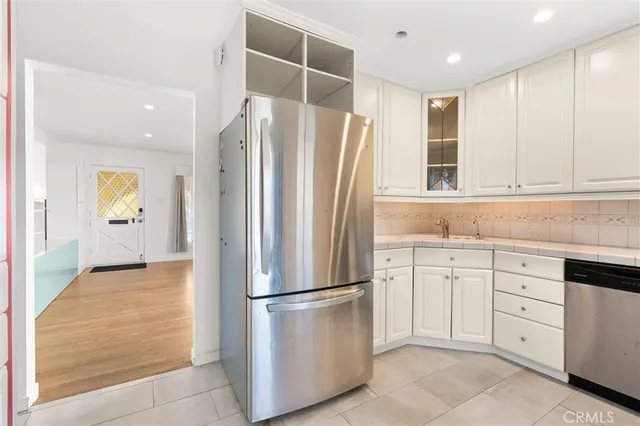 a kitchen with cabinets and stainless steel appliances