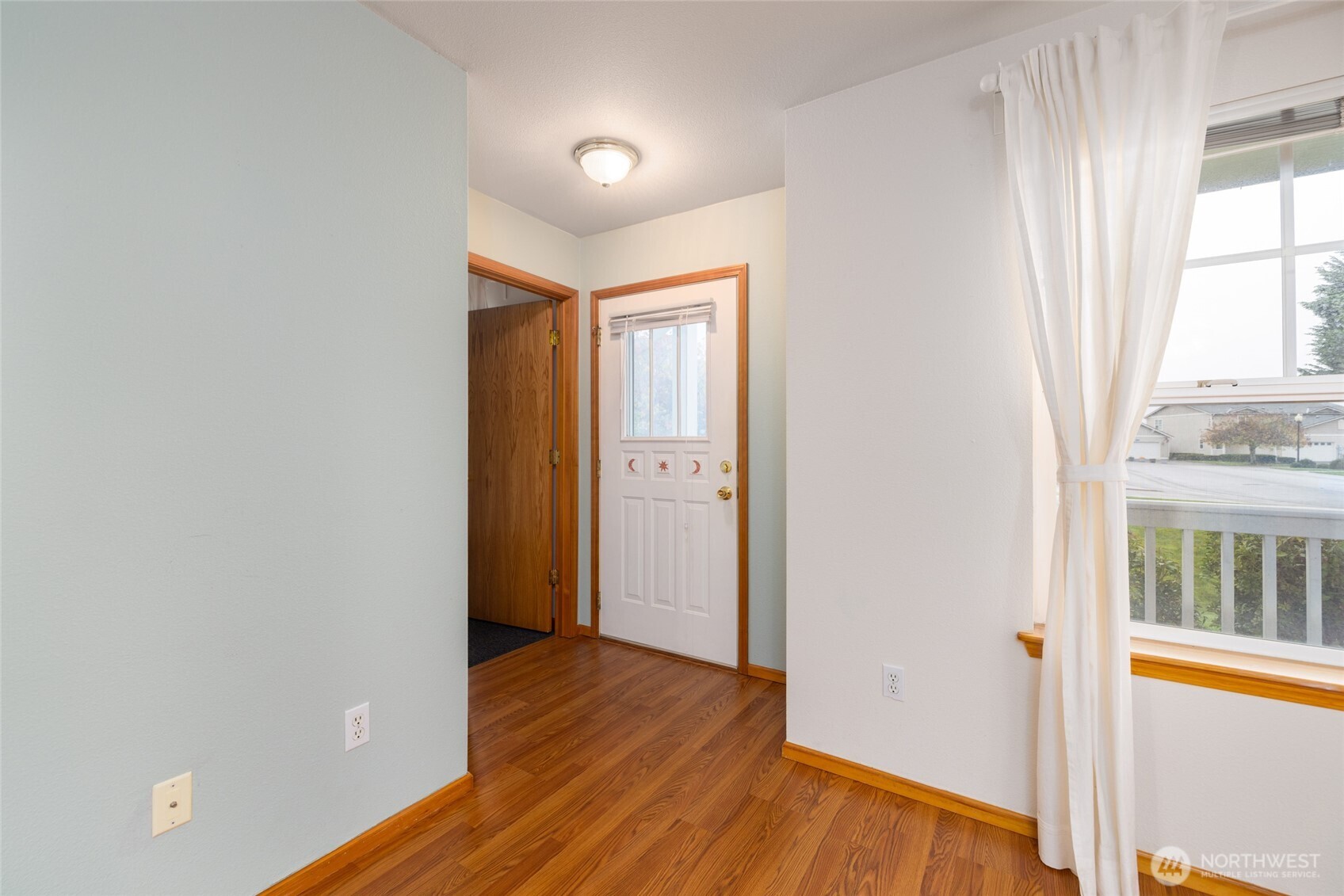 1154 Sinclair Way Burlington, WA 98233 - Photo 4 of 22 an empty room with wooden floor and windows