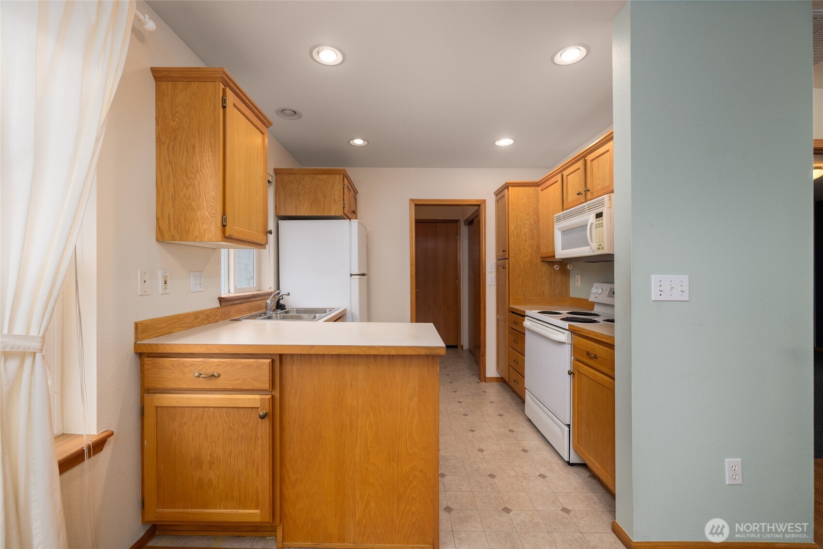 1154 Sinclair Way Burlington, WA 98233 - Photo 8 of 22 a kitchen with stainless steel appliances granite countertop a sink a stove and a refrigerator