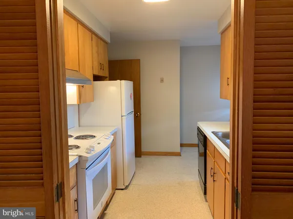 a kitchen with a refrigerator and a stove