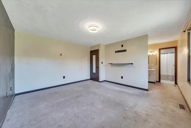 an empty room with windows and closet