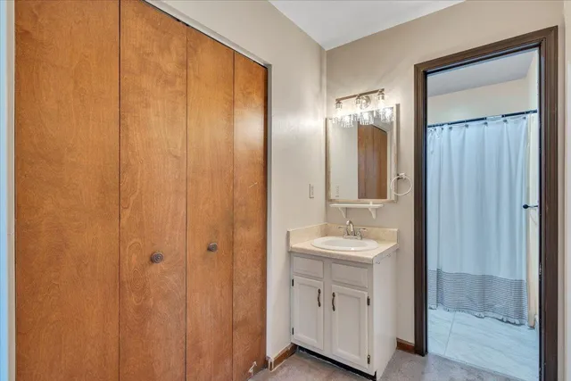 an empty room with a ceiling fan and a window
