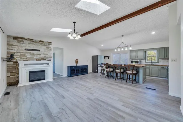 a view of empty room with wooden floor and fireplace