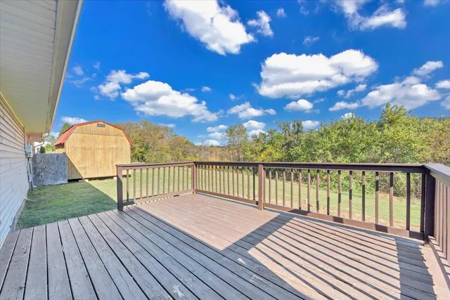 a front view of a house with yard and green space