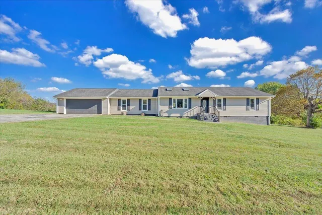 a swimming pool with yard in front of it