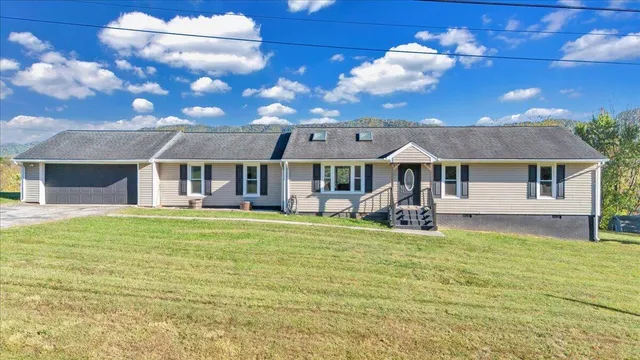 a backyard of a house with table and chairs