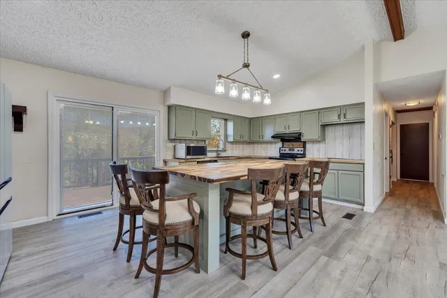 a kitchen with a sink stove and cabinets