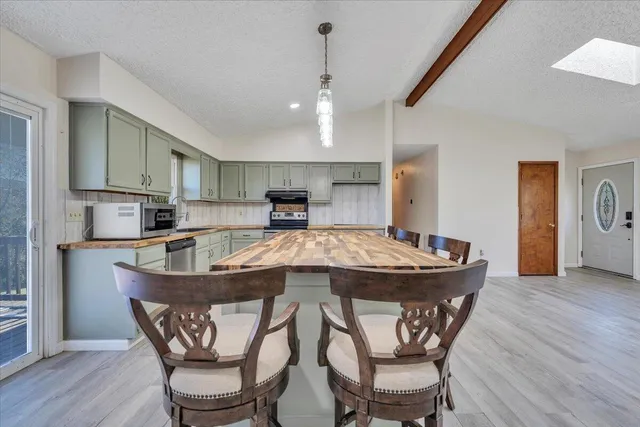 a kitchen with granite countertop cabinets stainless steel appliances and a sink