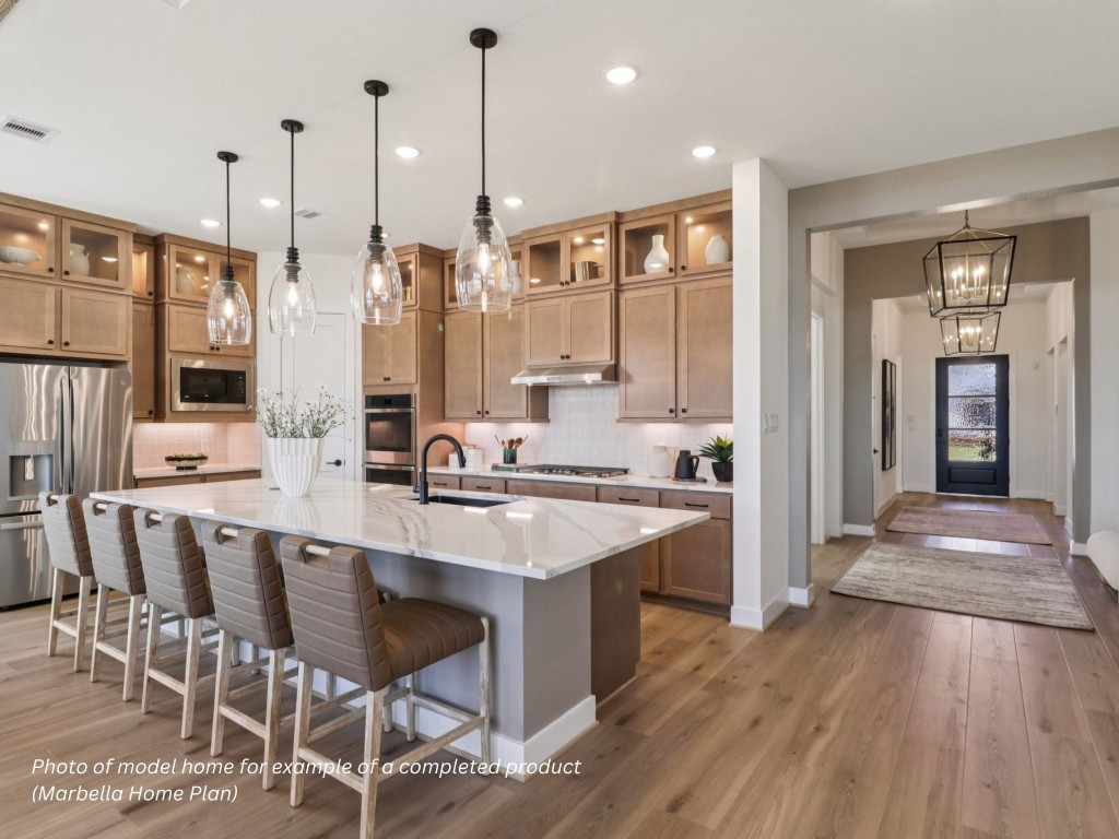 16847 Deep Wingbeat Way Magnolia, TX 77354 - Photo 2 of 16 a large kitchen with kitchen island a island in the center