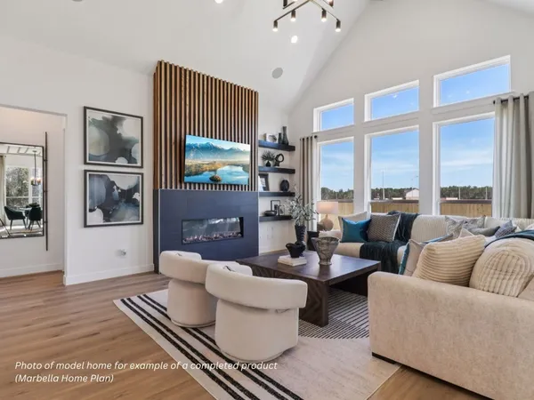 a living room with furniture and a floor to ceiling window