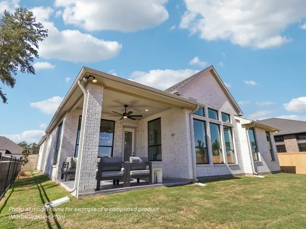 a view of a house with backyard porch and furniture