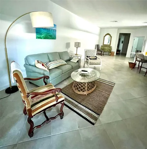 a living room with furniture and a mirror