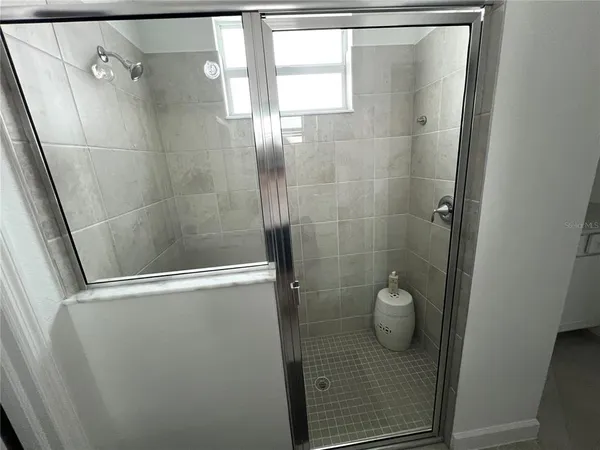 a bathroom with a glass shower door