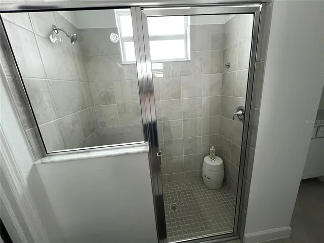 a bathroom with a glass shower door