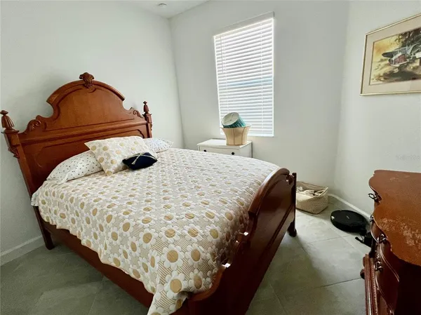 a bedroom with bed and window