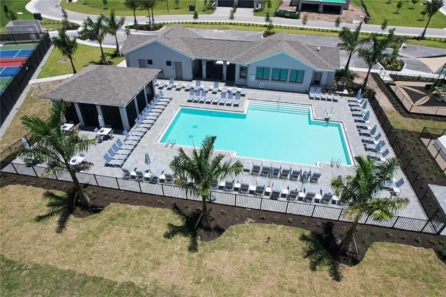 a view of a swimming pool and lounge chairs