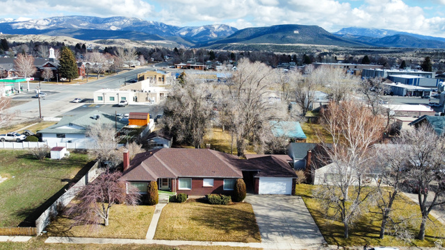 160 North 100 W Street Beaver, UT 84713 - Photo 34 of 36 Aerial perspective of suburban area featuring mountains