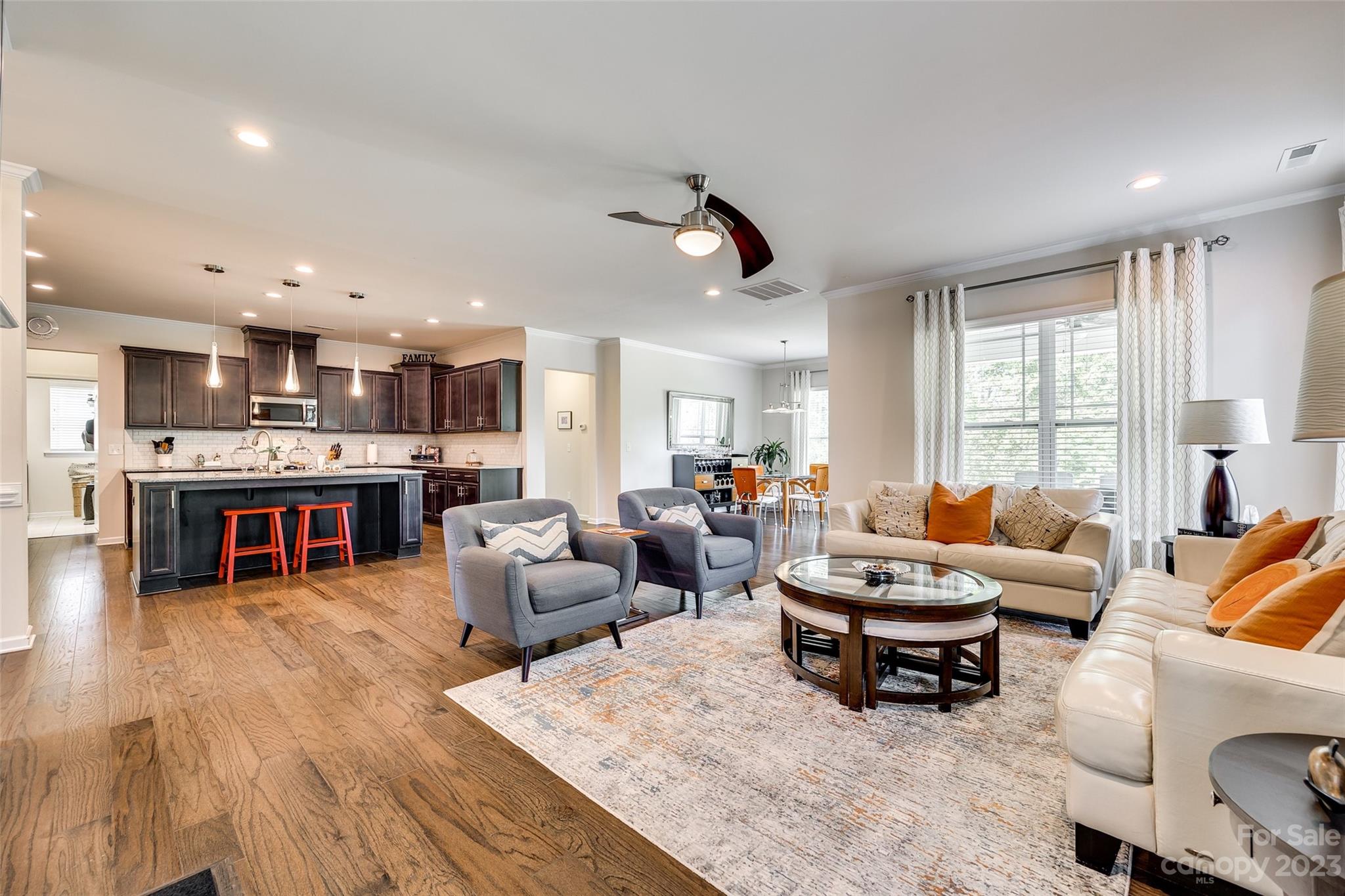 423 Harrier Crossing Circle Fort Mill, SC 29708 - Photo 12 of 36 a living room with furniture and a kitchen area