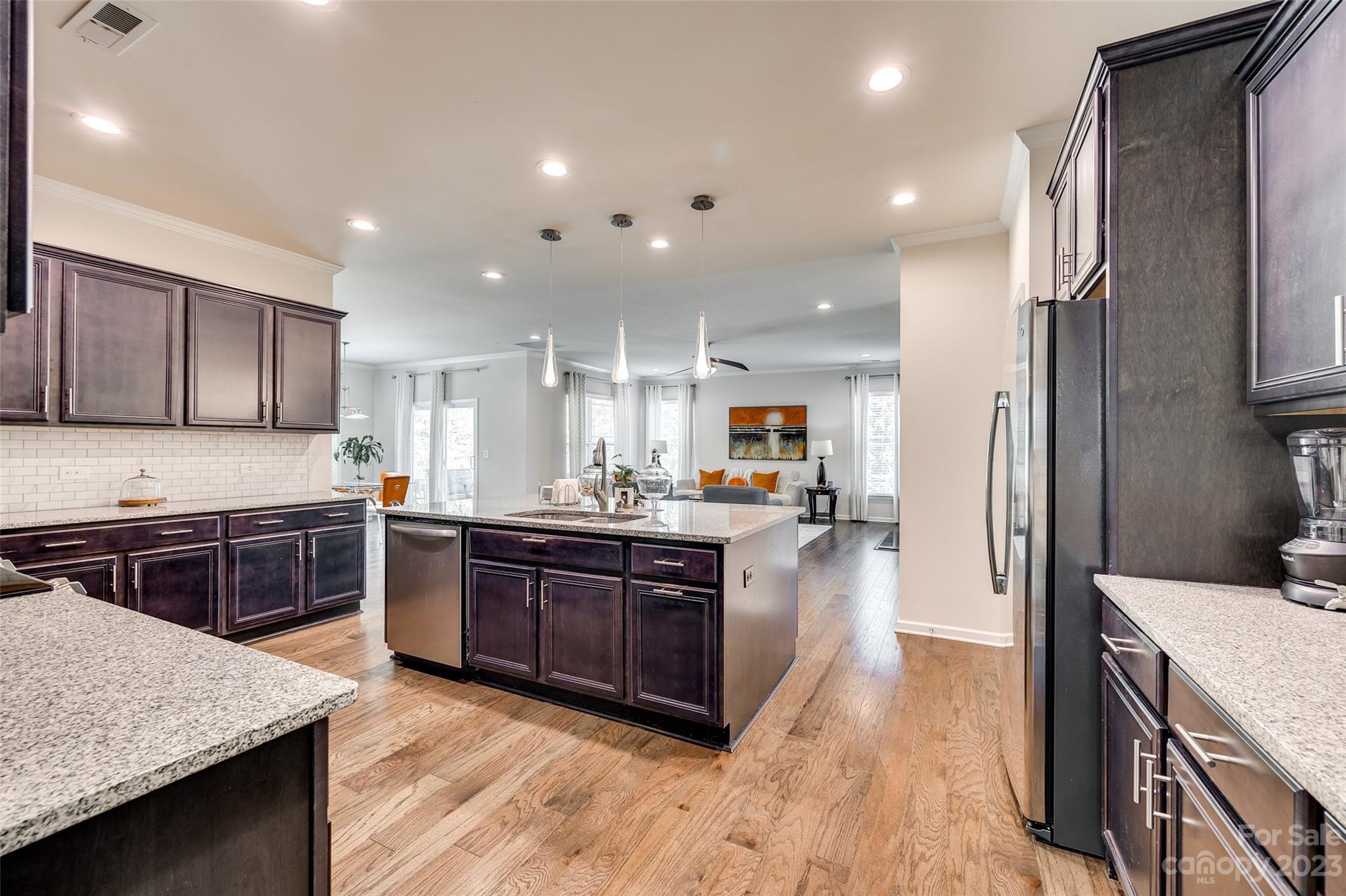 423 Harrier Crossing Circle Fort Mill, SC 29708 - Photo 15 of 36 a large kitchen with stainless steel appliances and wooden cabinets