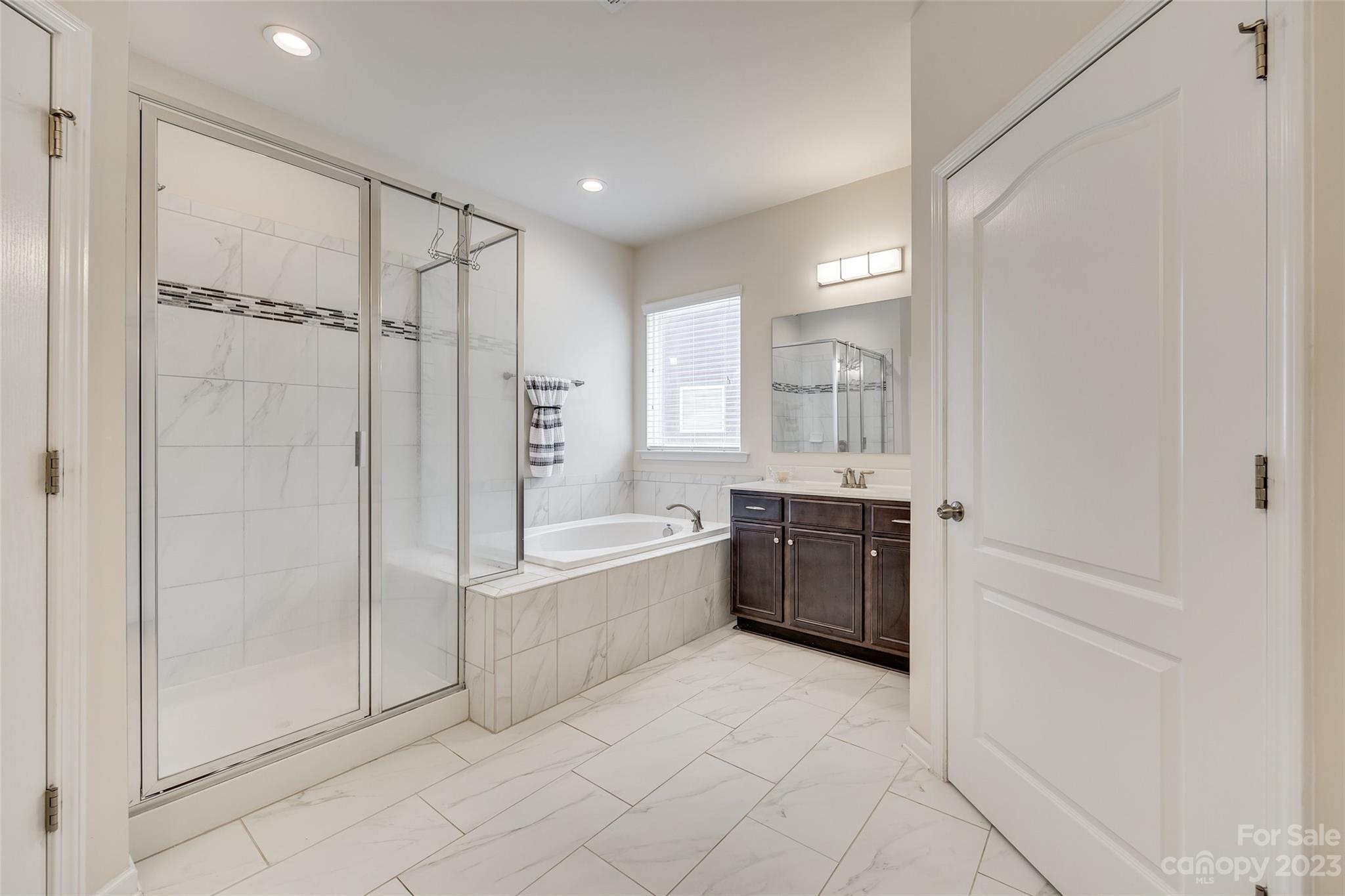 423 Harrier Crossing Circle Fort Mill, SC 29708 - Photo 23 of 36 a large bathroom with a tub shower and sink