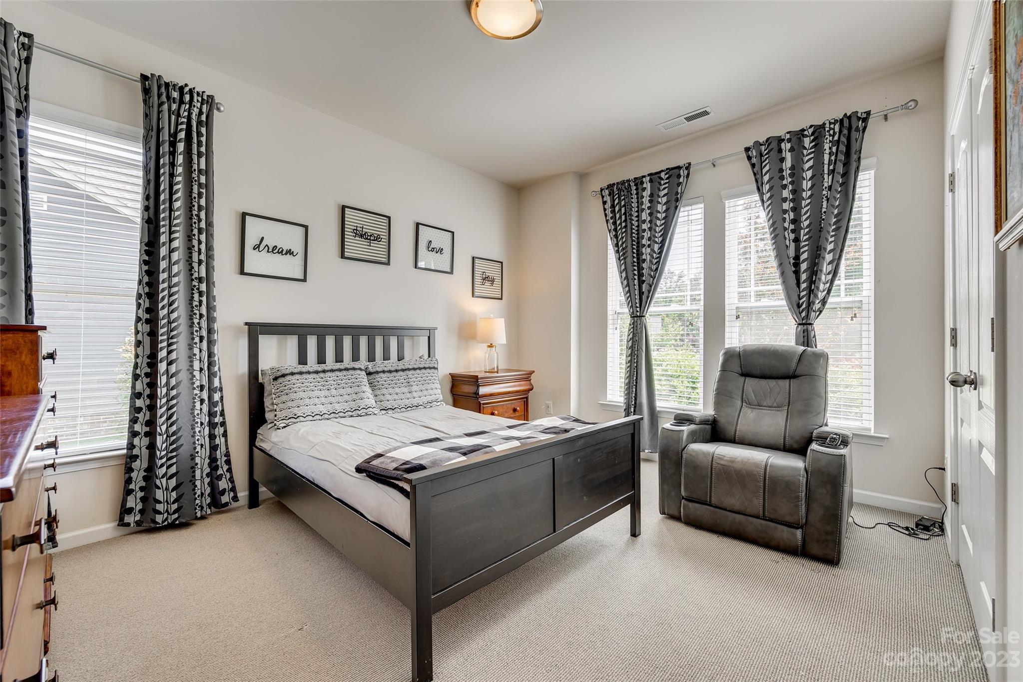 423 Harrier Crossing Circle Fort Mill, SC 29708 - Photo 6 of 36 a bedroom with a bed and a couch