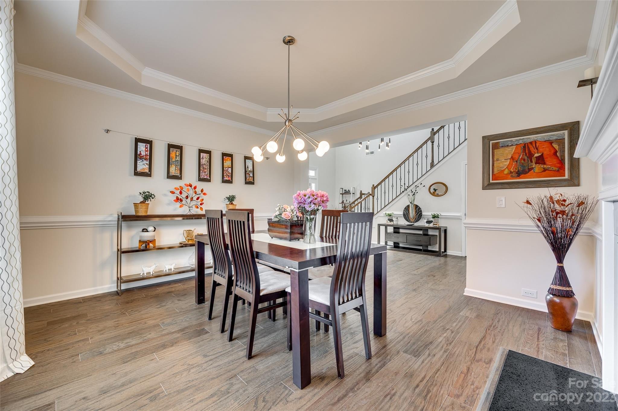 423 Harrier Crossing Circle Fort Mill, SC 29708 - Photo 9 of 36 a view of a dining room with furniture and wooden floor