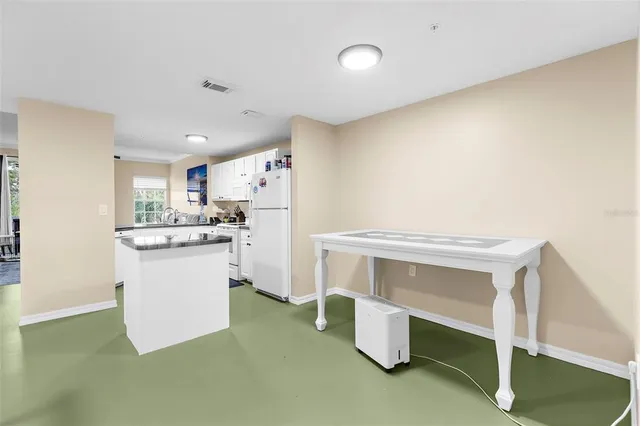 a kitchen with a sink and white cabinets