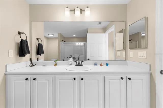 a bathroom with a double vanity sink and a mirror