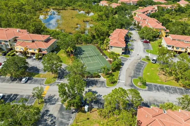an aerial view of residential house with outdoor space and parking