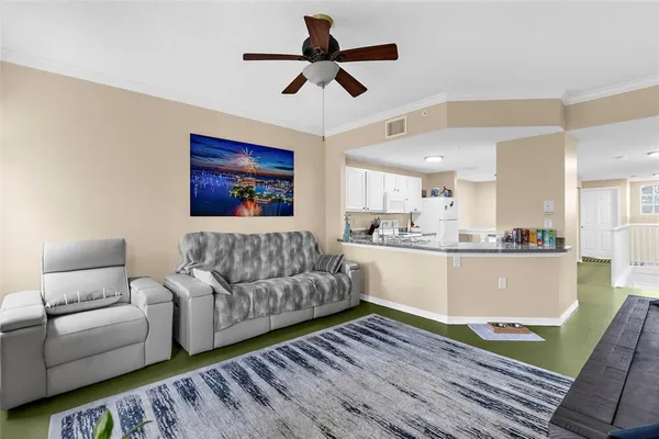 a living room with furniture and a chandelier