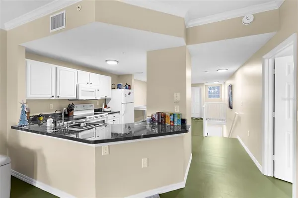 a kitchen with stainless steel appliances a white cabinets stove a sink and dishwasher