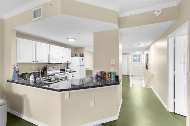 a kitchen with stainless steel appliances a white cabinets stove a sink and dishwasher