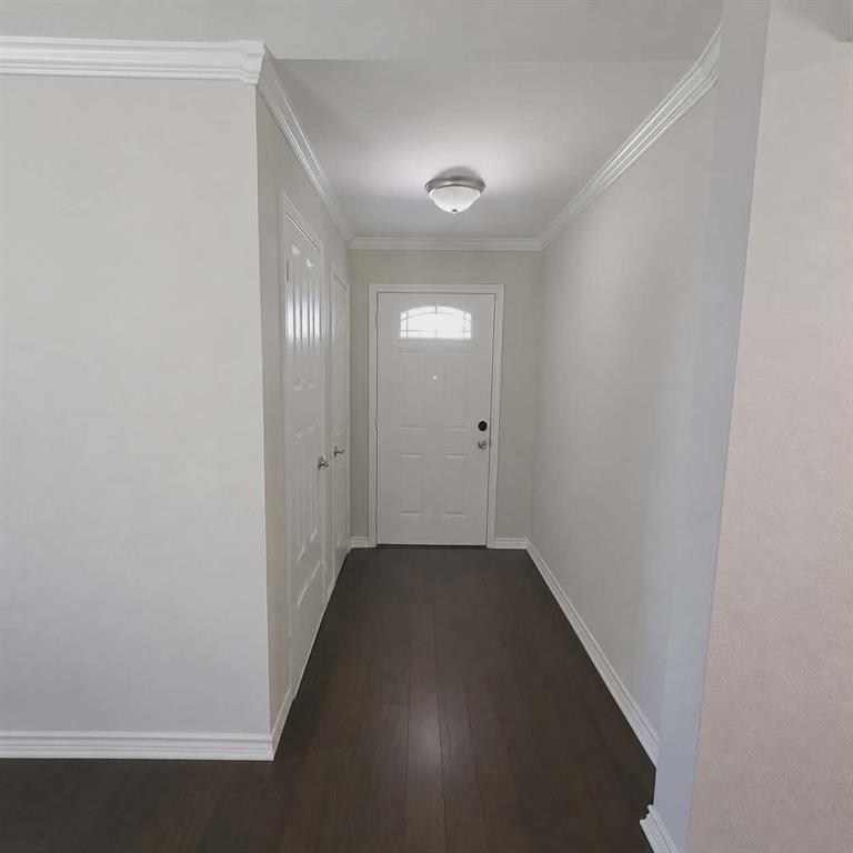 14752 Ranch Road Forney, TX 75126 - Photo 5 of 40 Main front door- Entryway featuring a white exterior door with an arched window, rich wood-finish flooring, and crown molding