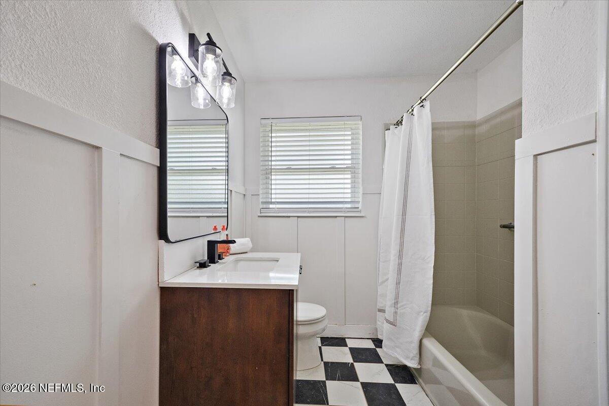 6923 Gaillardia Road South Jacksonville, FL 32211 - Photo 11 of 31 a bathroom with a sink a toilet and shower