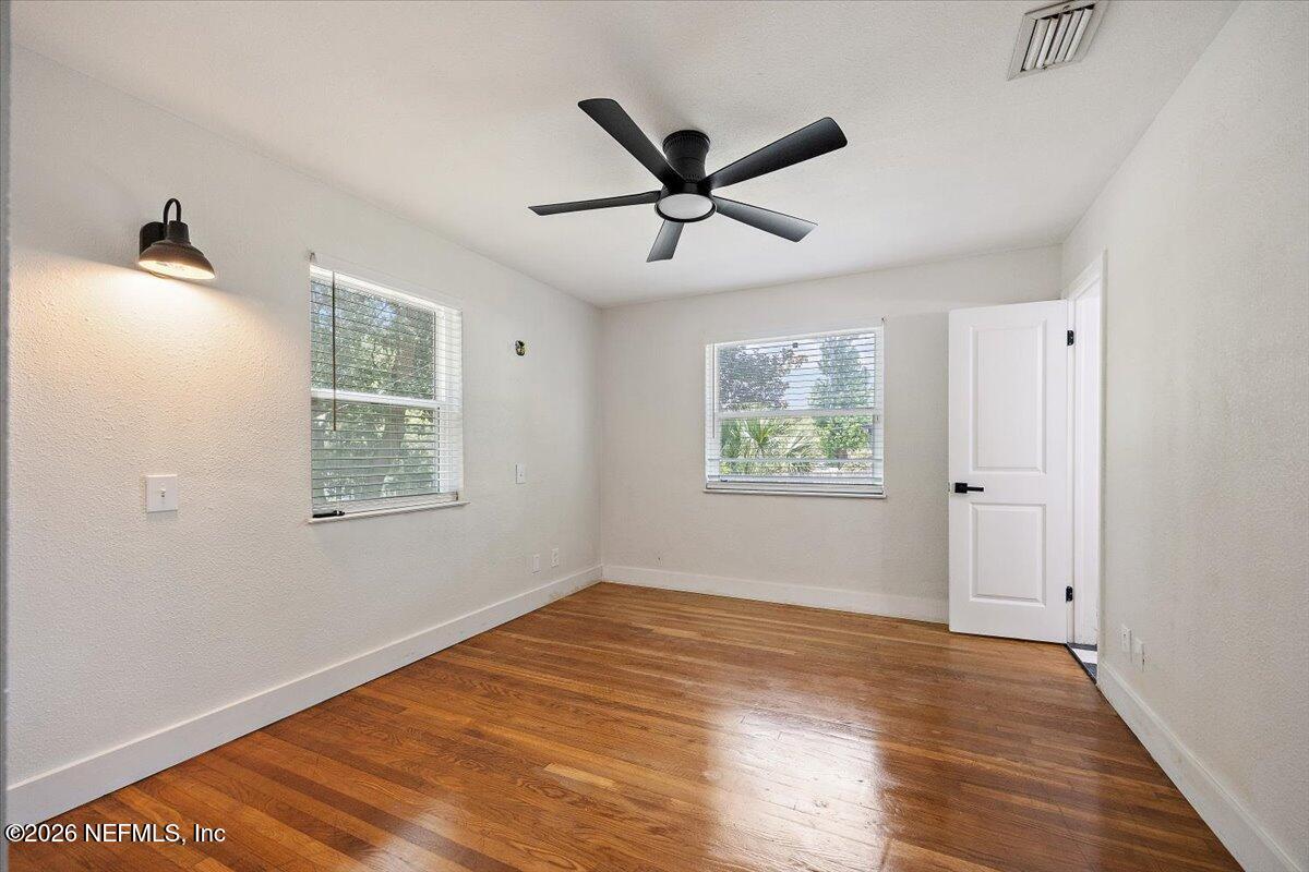 6923 Gaillardia Road South Jacksonville, FL 32211 - Photo 12 of 31 a view of empty room with wooden floor and fan