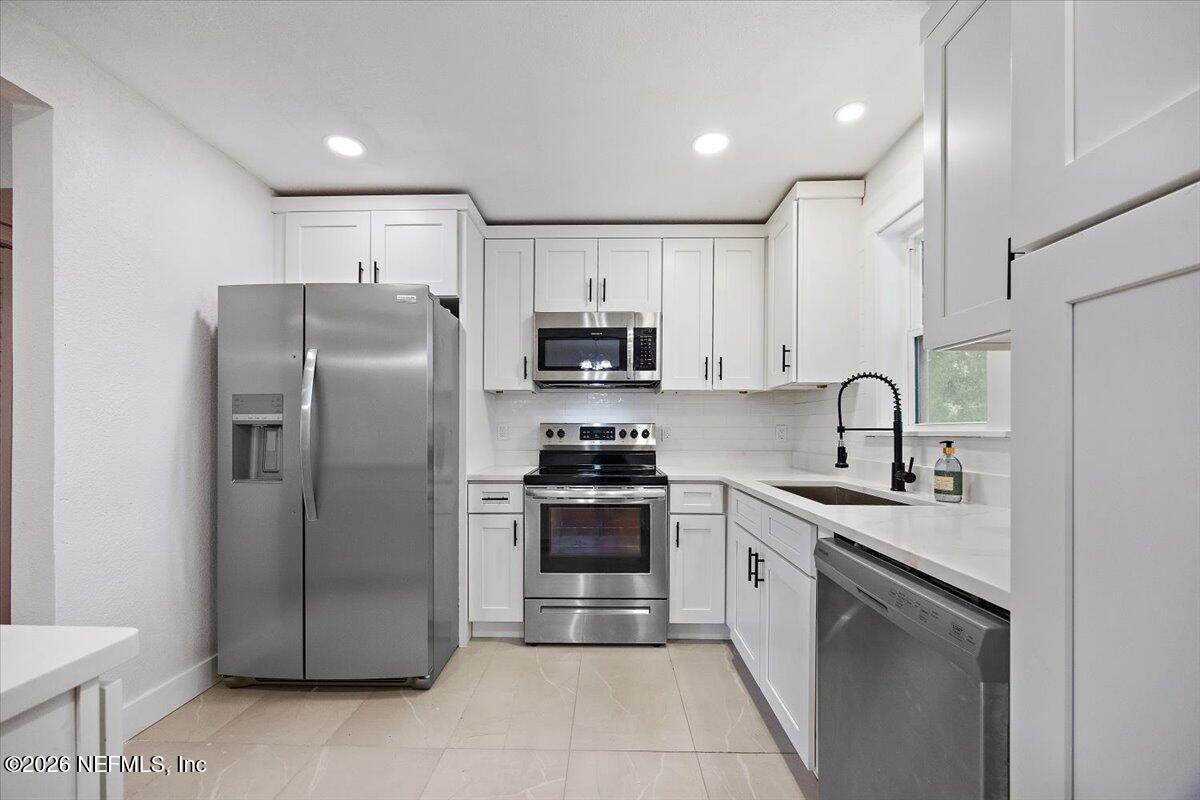 6923 Gaillardia Road South Jacksonville, FL 32211 - Photo 2 of 31 a kitchen with stainless steel appliances granite countertop a refrigerator sink and stove