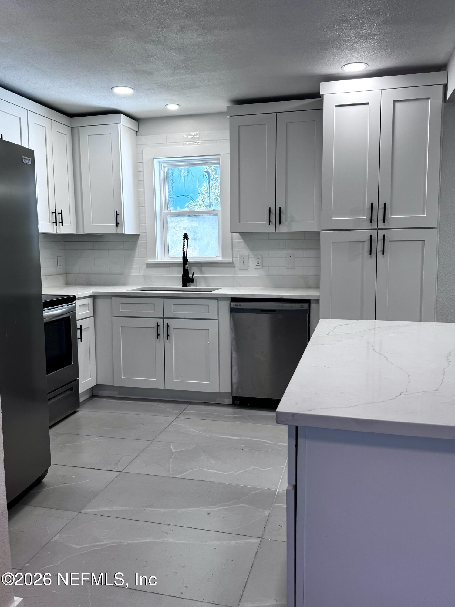 6923 Gaillardia Road South Jacksonville, FL 32211 - Photo 28 of 31 a kitchen with a sink appliances and cabinets