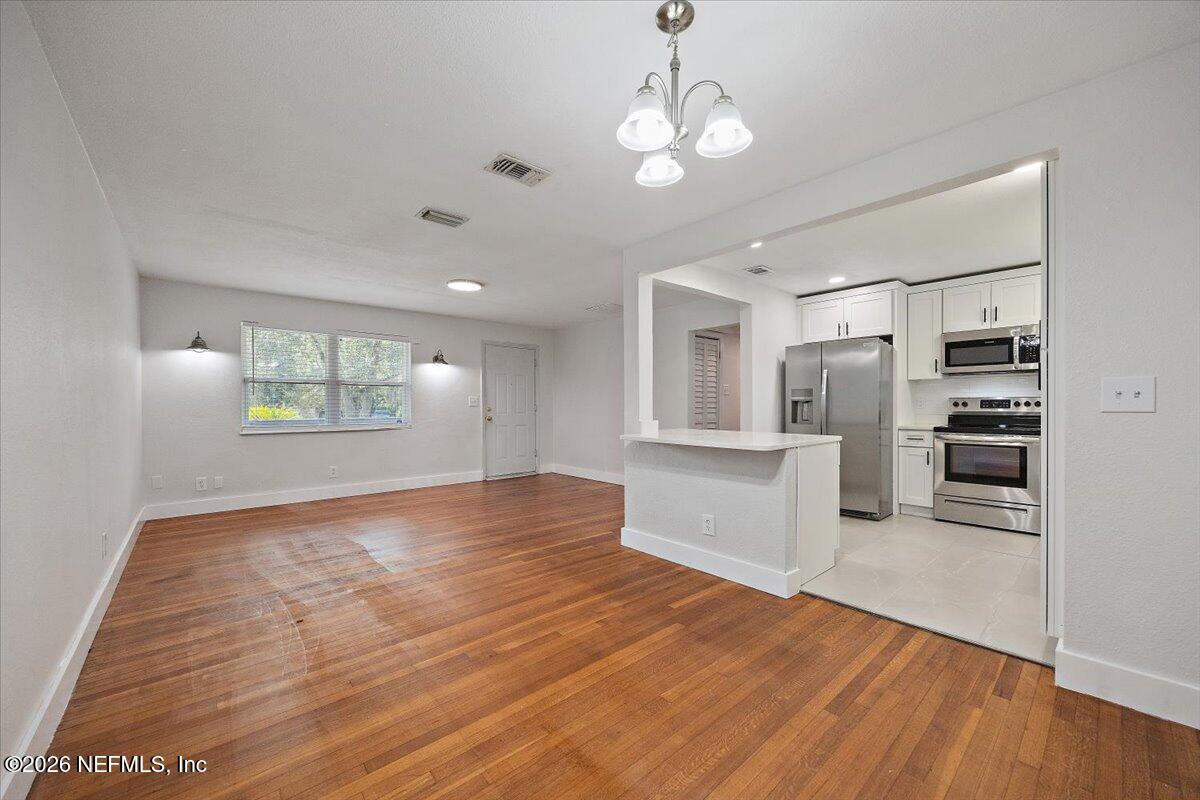 6923 Gaillardia Road South Jacksonville, FL 32211 - Photo 3 of 31 a view of a kitchen with microwave and refrigerator