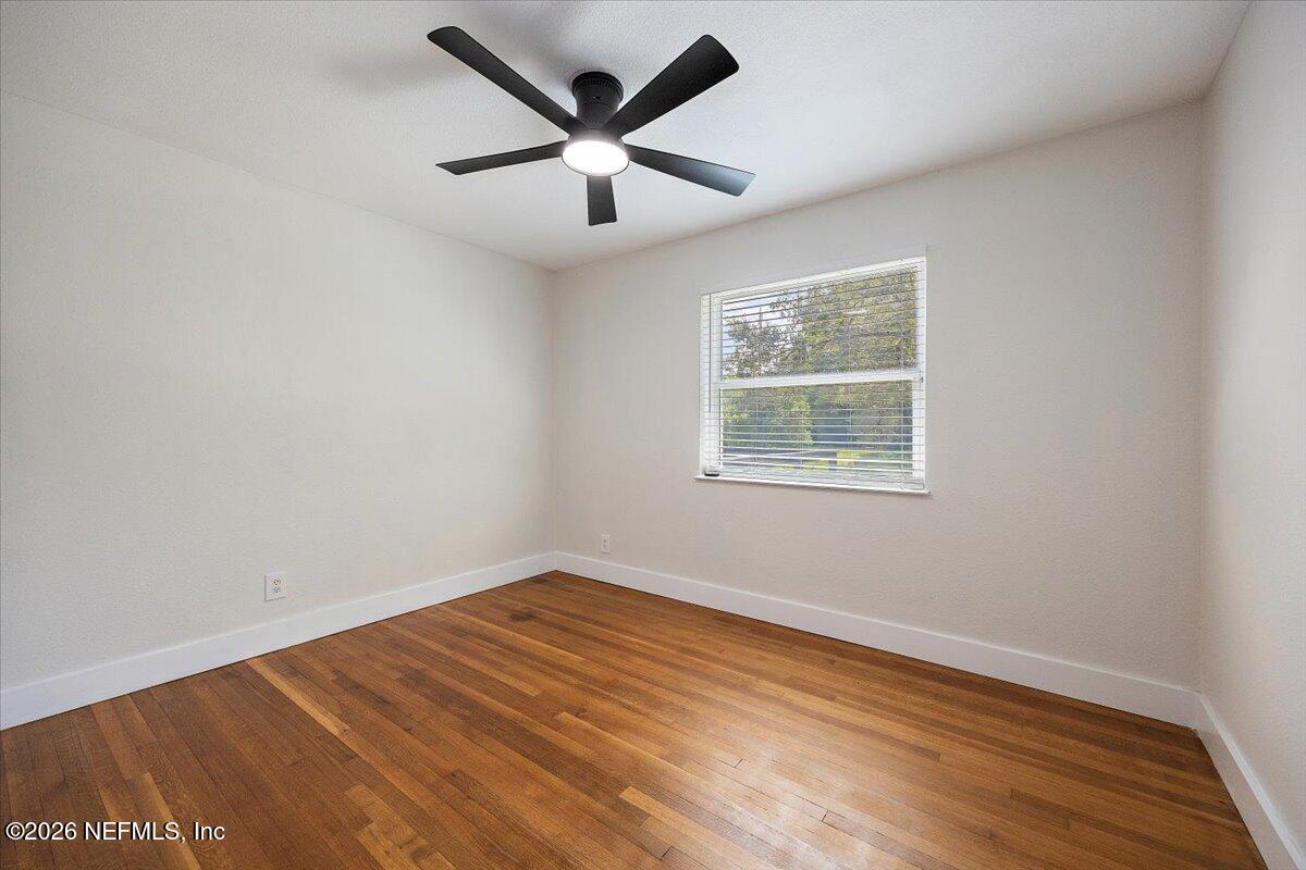 6923 Gaillardia Road South Jacksonville, FL 32211 - Photo 6 of 31 an empty room with wooden floor and windows