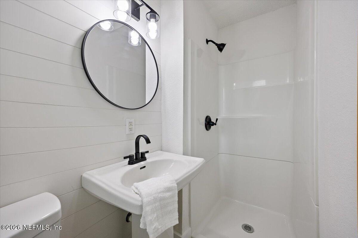 6923 Gaillardia Road South Jacksonville, FL 32211 - Photo 7 of 31 a bathroom with a sink a toilet and a mirror