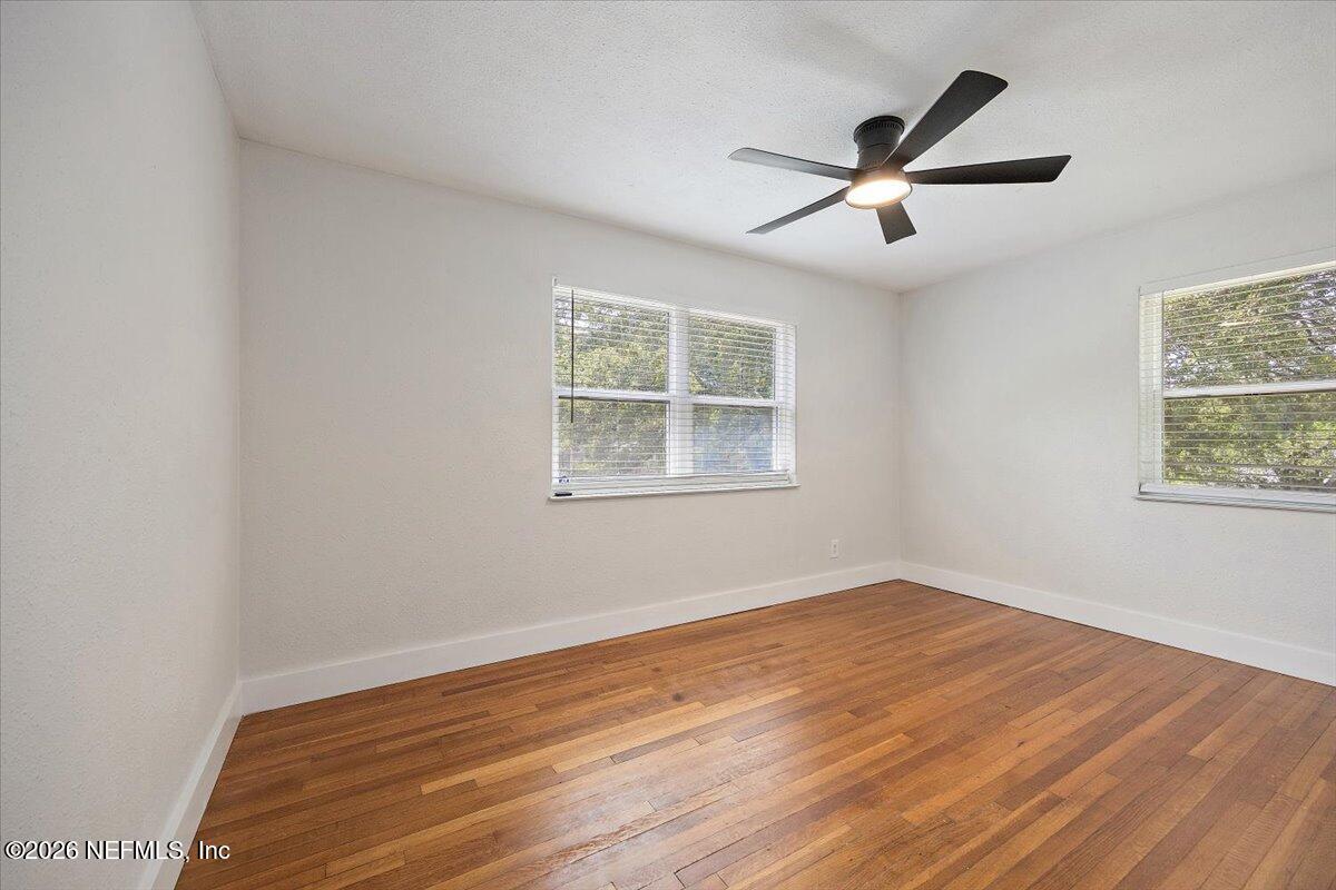 6923 Gaillardia Road South Jacksonville, FL 32211 - Photo 8 of 31 a view of empty room with wooden floor and fan
