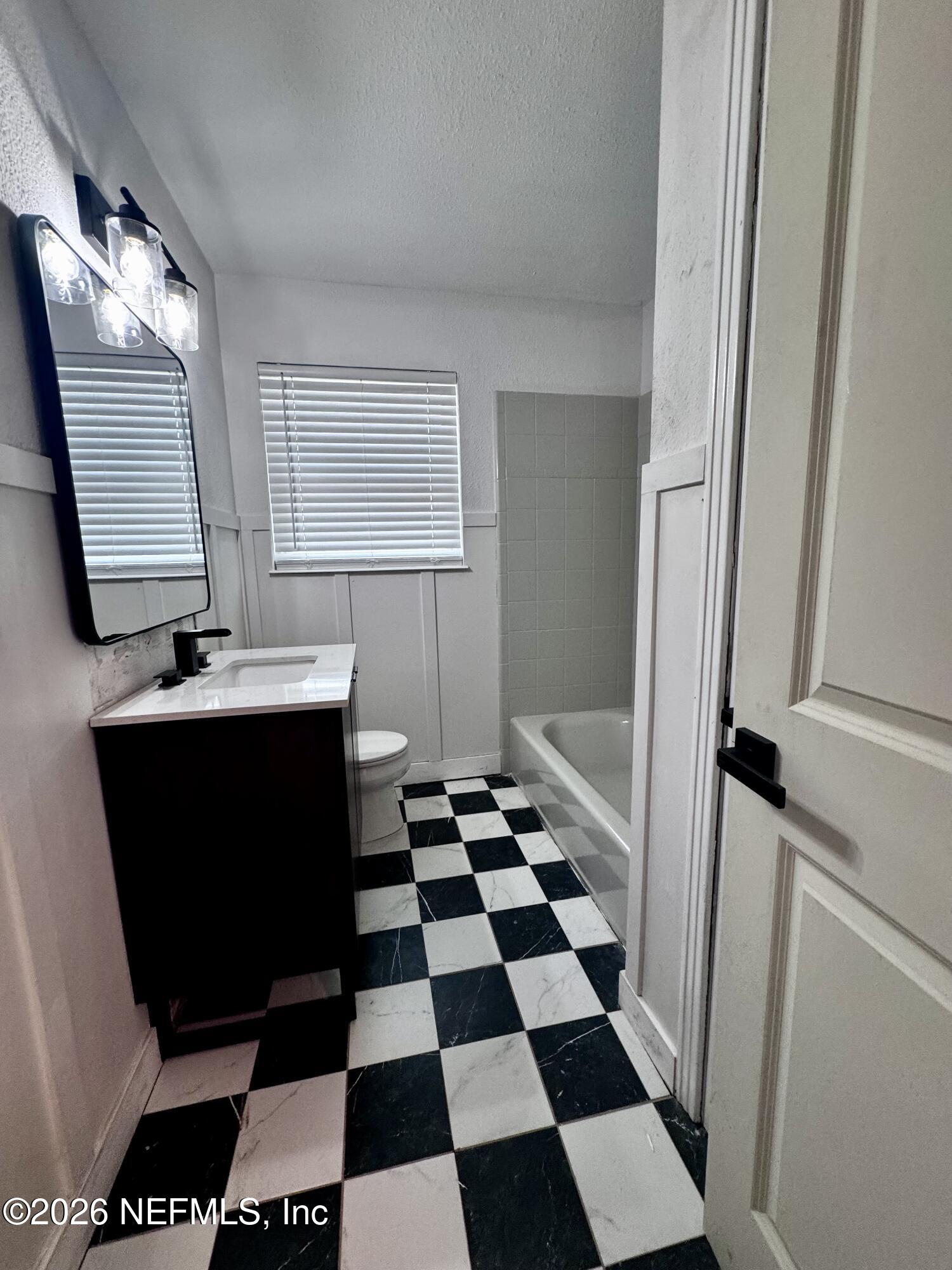 6923 Gaillardia Road South Jacksonville, FL 32211 - Photo 10 of 31 a black and white checkered floor with a black white checkered floor