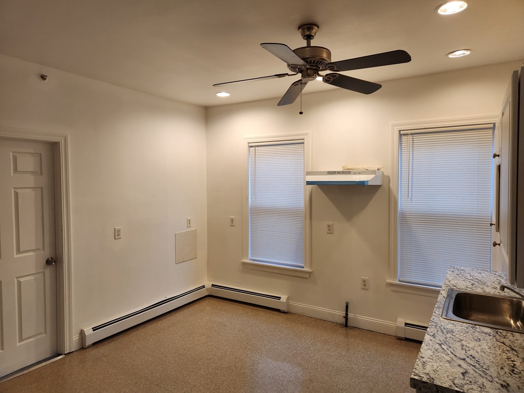 a view of an empty room and a ceiling fan