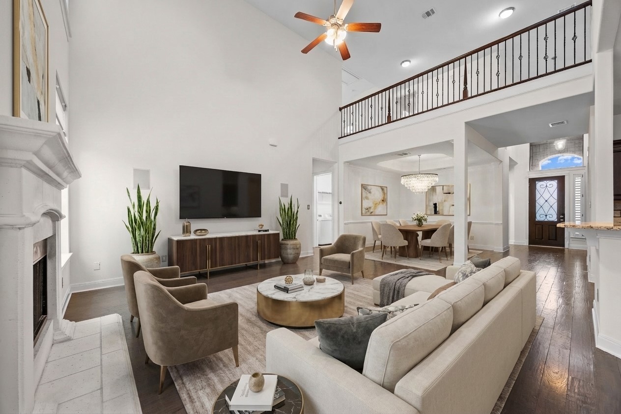 2300 Lakehurst Road Spicewood, TX 78669 - Photo 11 of 40 Living area with a ceiling fan, dark wood finished floors, a fireplace, a high ceiling, and hanging lights- virtually staged
