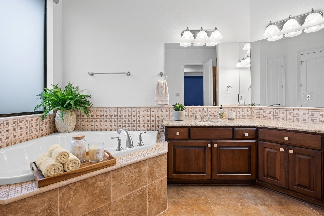 2300 Lakehurst Road Spicewood, TX 78669 - Photo 17 of 40 Bathroom featuring vanity and a garden tub- virtually staged