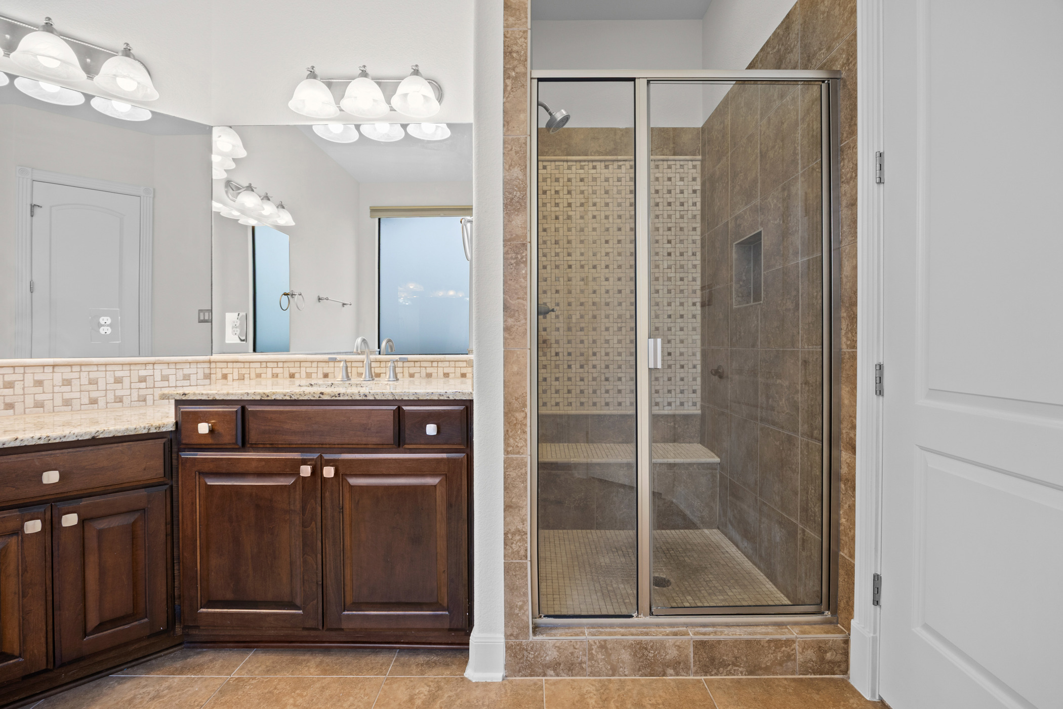 2300 Lakehurst Road Spicewood, TX 78669 - Photo 18 of 40 Bathroom featuring vanity, a stall shower, and light tile patterned floors