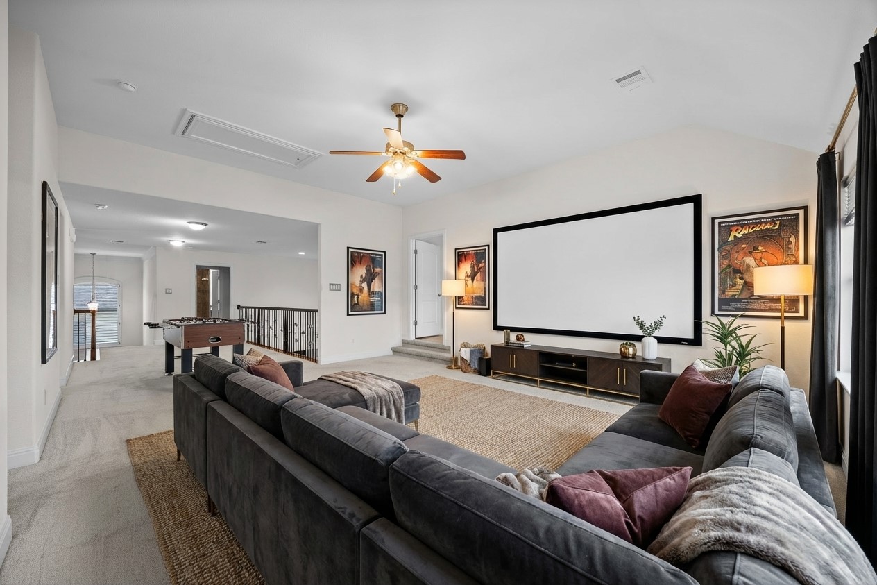 2300 Lakehurst Road Spicewood, TX 78669 - Photo 19 of 40 Cinema featuring light carpet and ceiling fan- virtually staged