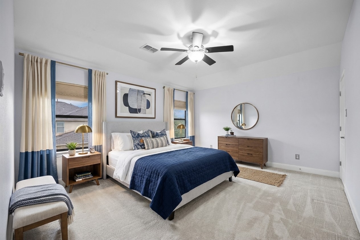 2300 Lakehurst Road Spicewood, TX 78669 - Photo 20 of 40 Bedroom featuring light colored carpet and a ceiling fan- virtually staged