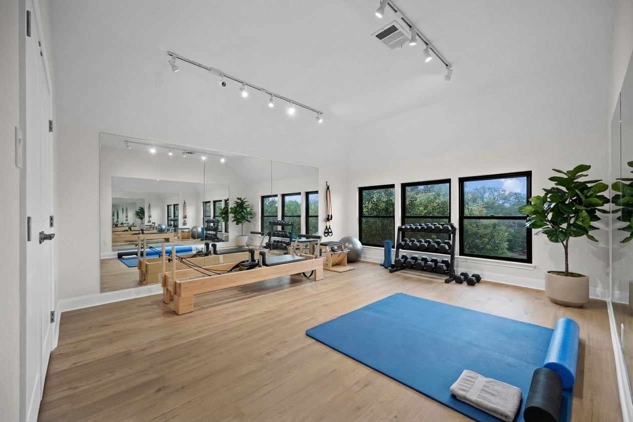 2300 Lakehurst Road Spicewood, TX 78669 - Photo 23 of 40 Workout area with vaulted ceiling and track lighting- virtually staged