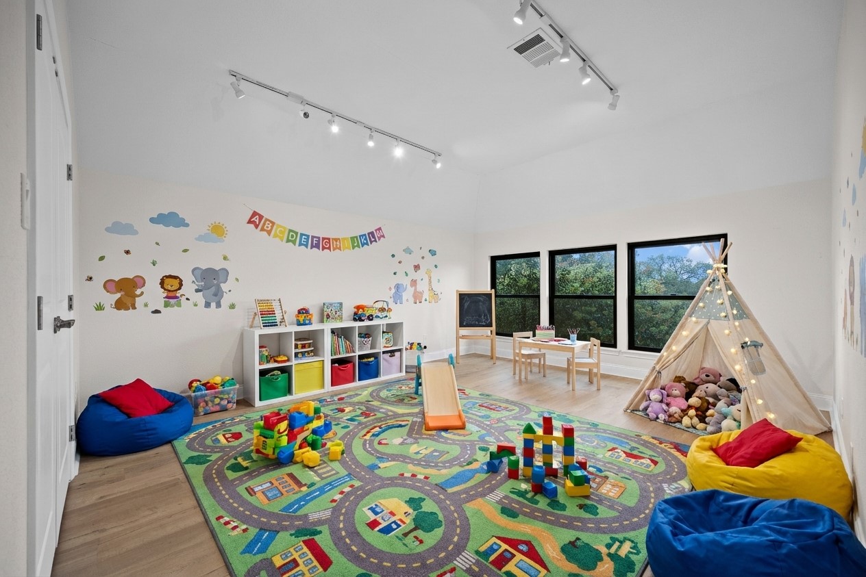 2300 Lakehurst Road Spicewood, TX 78669 - Photo 24 of 40 Game room featuring light wood finished floors and rail lighting- virtually staged